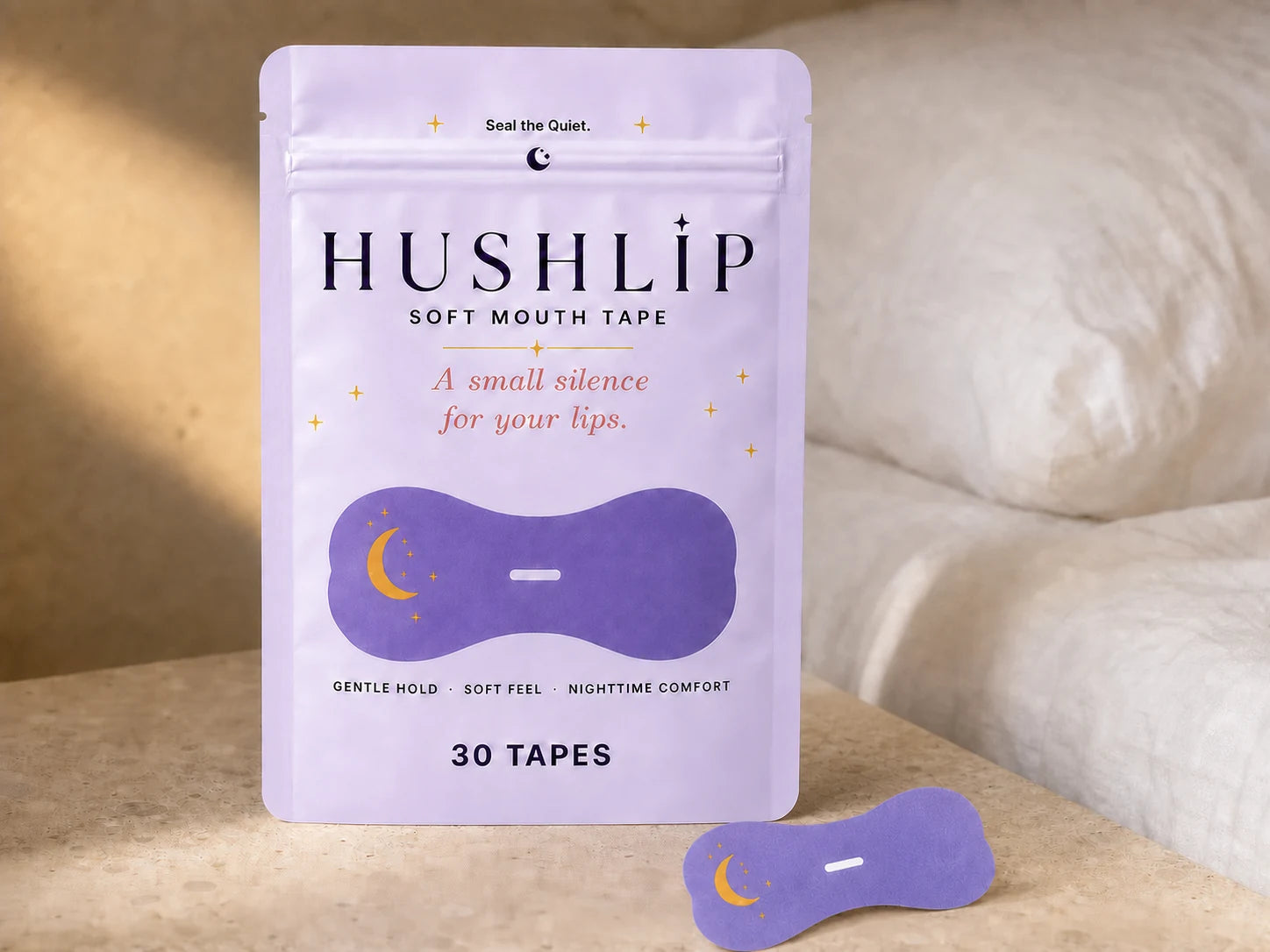 HUSHLIP soft mouth tape package and one lavender strip on a natural bedside surface